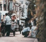A glimpse into the vibrant street life of a traditional hutong in Beijing, China, showcasing daily interactions.